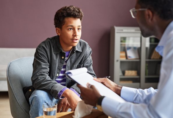 A young adult receives an autism evaluation from a trained professional.